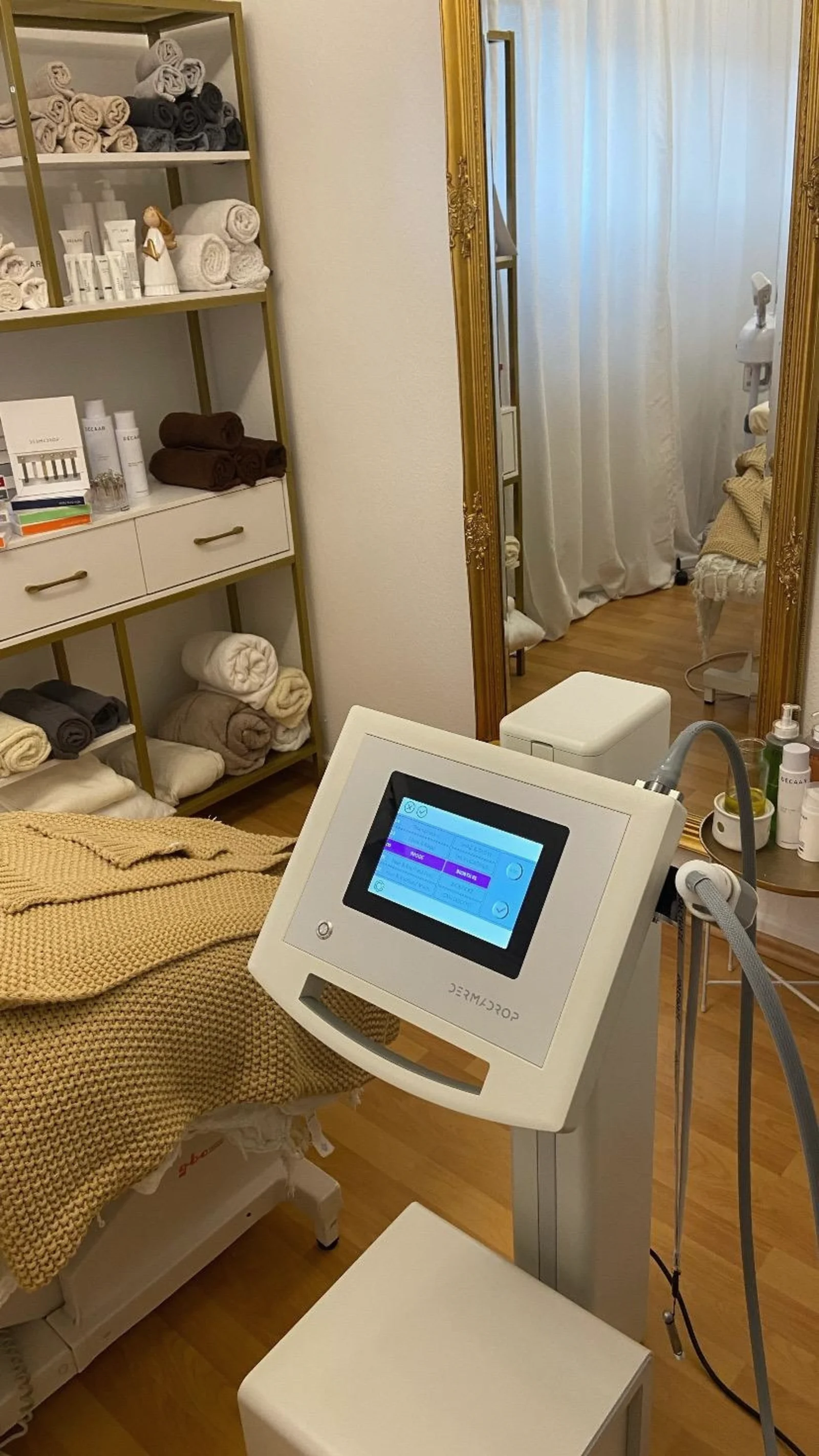 DERMADROP-Behandlungsplatz mit goldenem Wandspiegel im Aesthetic Beauty Day Spa Kerpen